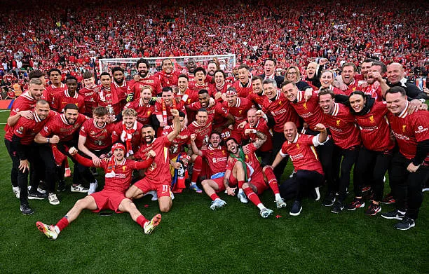 Premier League 2024–25 season: Liverpool players pose for a photo as they celebrate the teams victory and confirmation of winning the Premier League title after the Premier League match between Liverpool and Tottenham at Anfield on April 27, 2025.