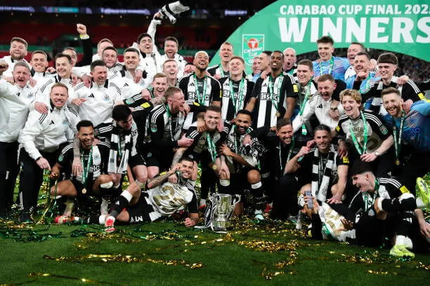 Premier League 2024–25 season: Newcastle players celebrate with the Carabao Cup trophy after the Carabao Cup Final between Liverpool and Newcastle at Wembley Stadium on March 16, 2025.